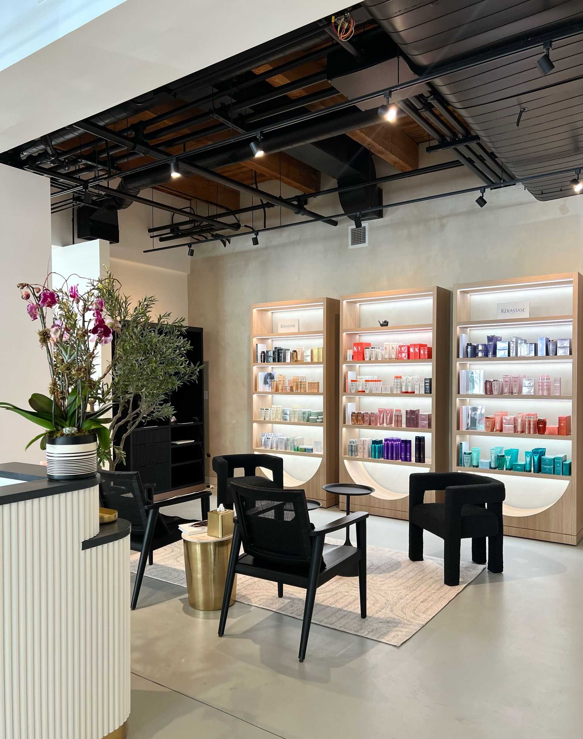 Modern beauty salon interior with product shelves and seating area.